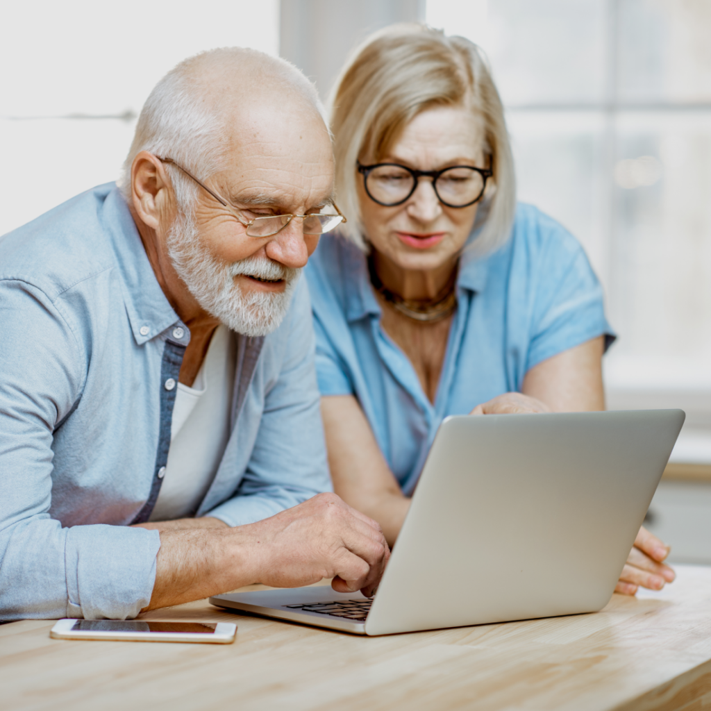 Joyful senior couple using a laptop together, sharing a moment of connection